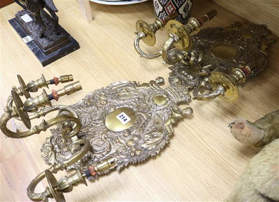 A pair of Dutch style oval embossed brass wall lights, H 40cm